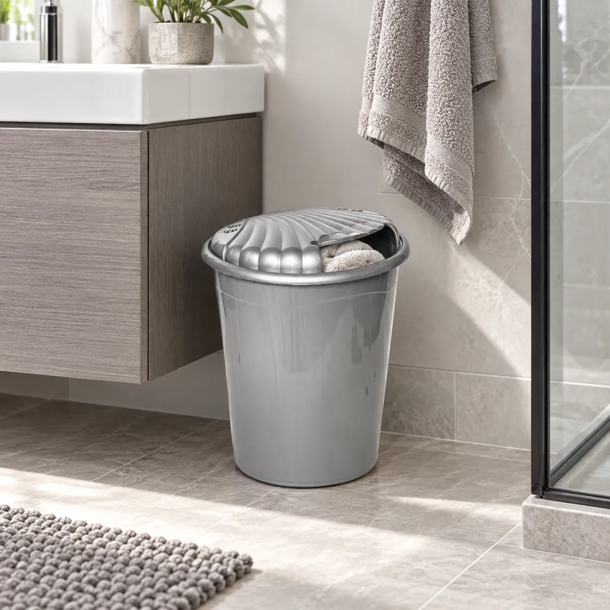 MINI LAUNDRY BIN used in a compact modern bathroom