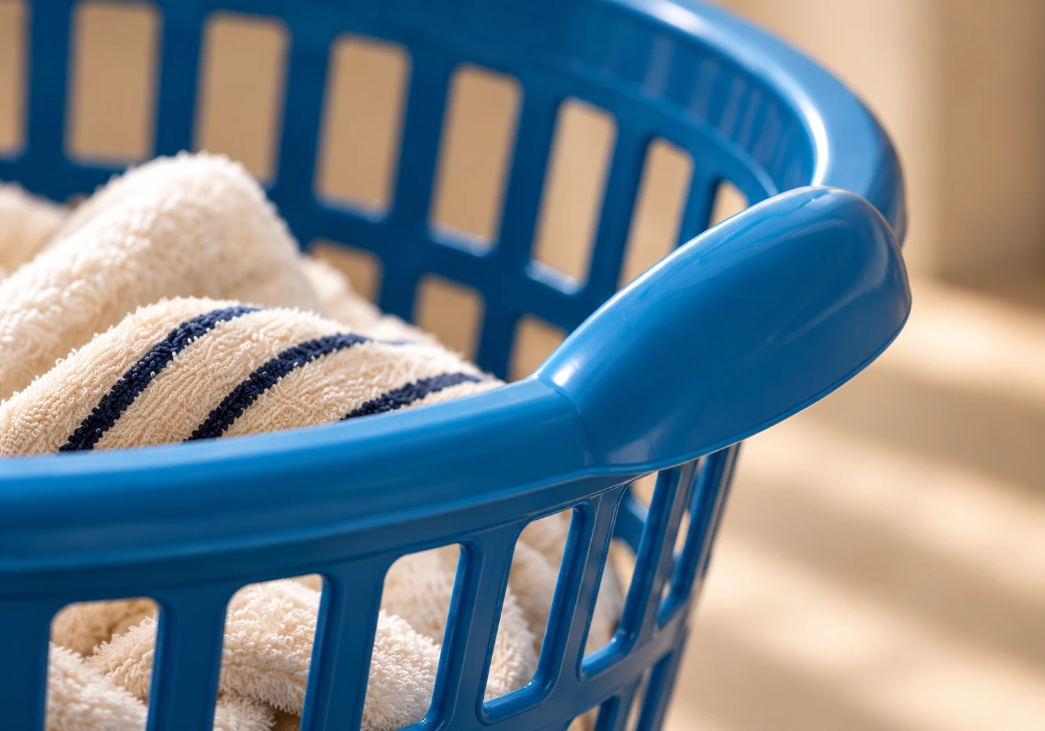 Rim of the blue laundry basket with soft cotton towels